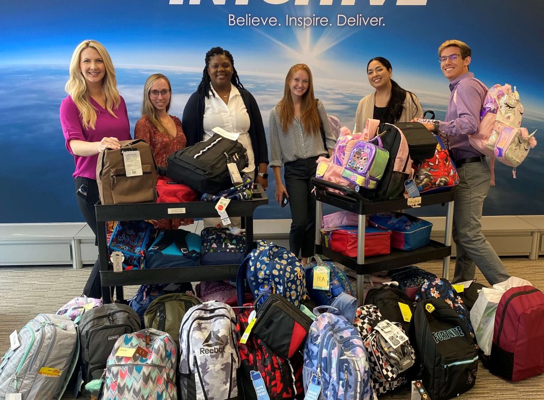 INTUITIVE employees with backpacks full of supplies that were donated to the National Child Advocacy Center.